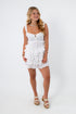 White voile Lucia romper with ruffles and adjustable straps for summer style