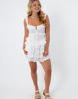 White voile Lucia romper with ruffles and adjustable straps for summer style
