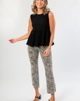 High-rise Kut Kelsey Leopard Pants styled with a sleeveless black top, featuring ankle flare cut and trendy animal print for a chic look.
