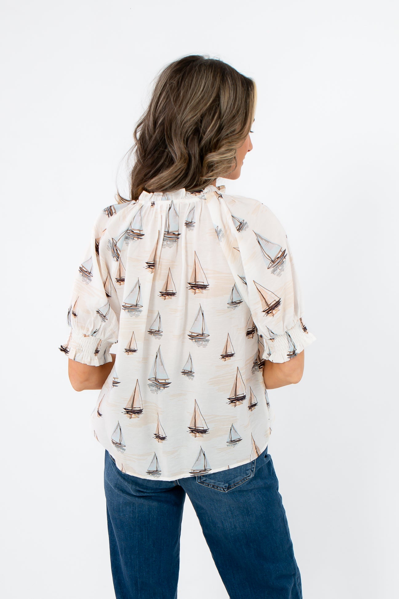 Back view of THML Sailboat Short Sleeve Blouse highlighting sailboat print and gathered neckline detail.