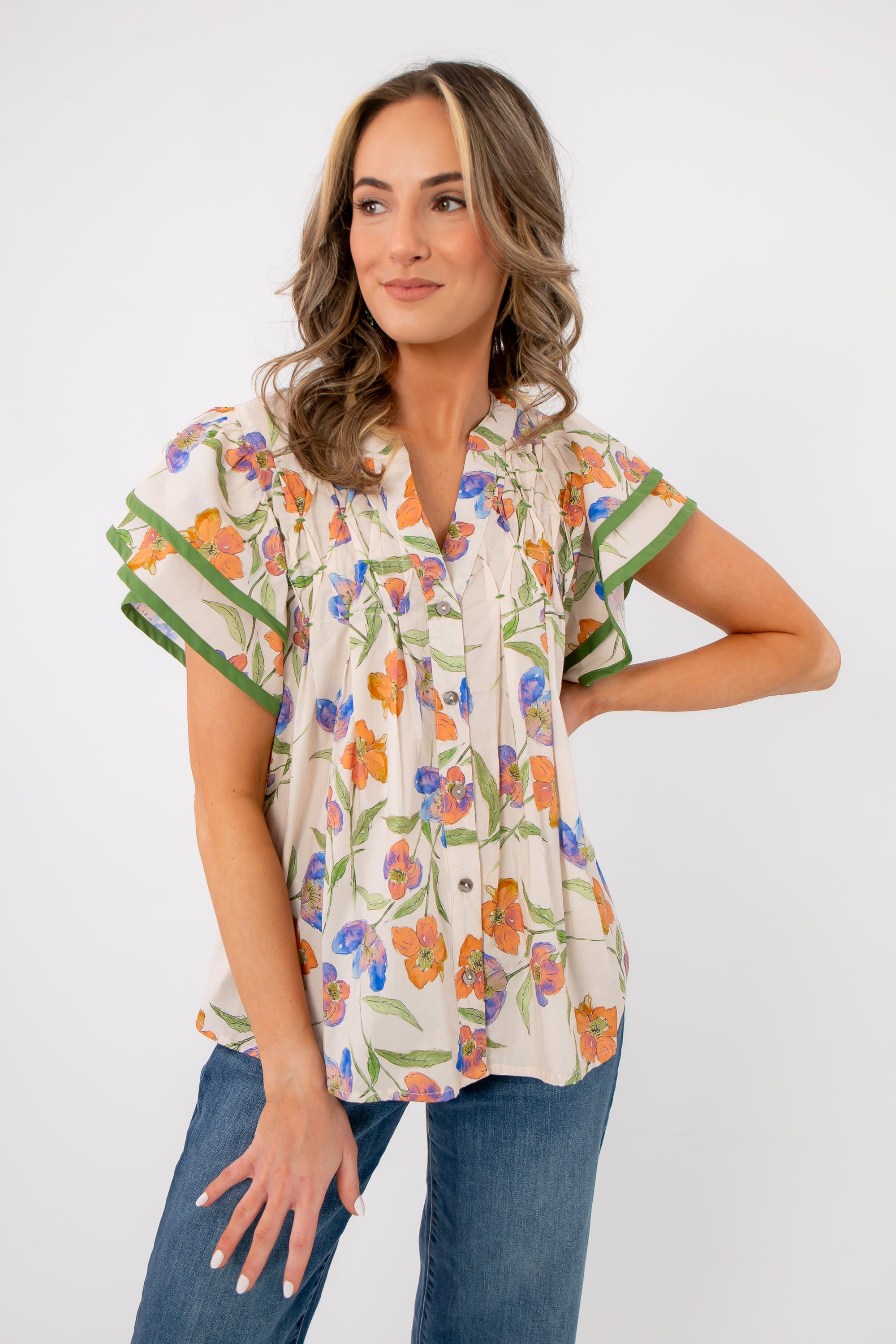 Model wearing Spring Fling Floral Ruffle Sleeve Blouse with relaxed fit and flutter sleeves, ideal for spring and summer styling.