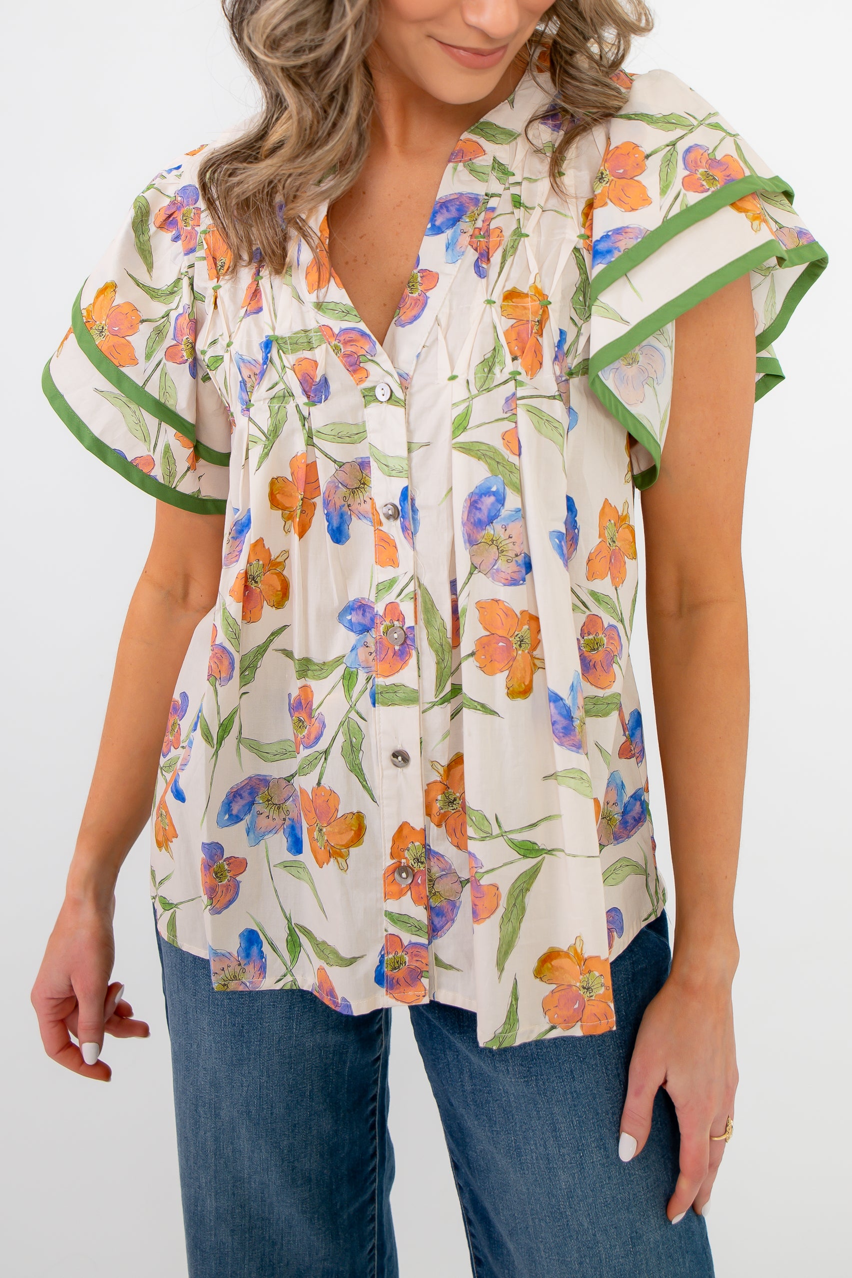 Close-up of Spring Fling Floral Ruffle Sleeve Blouse showing button-down front, vibrant floral pattern, and pleated detailing.