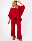 Free People Deep Cherry Staycation Pullover – Oversized cherry red sweatshirt with dropped shoulders and flowy silhouette, styled for casual comfort.