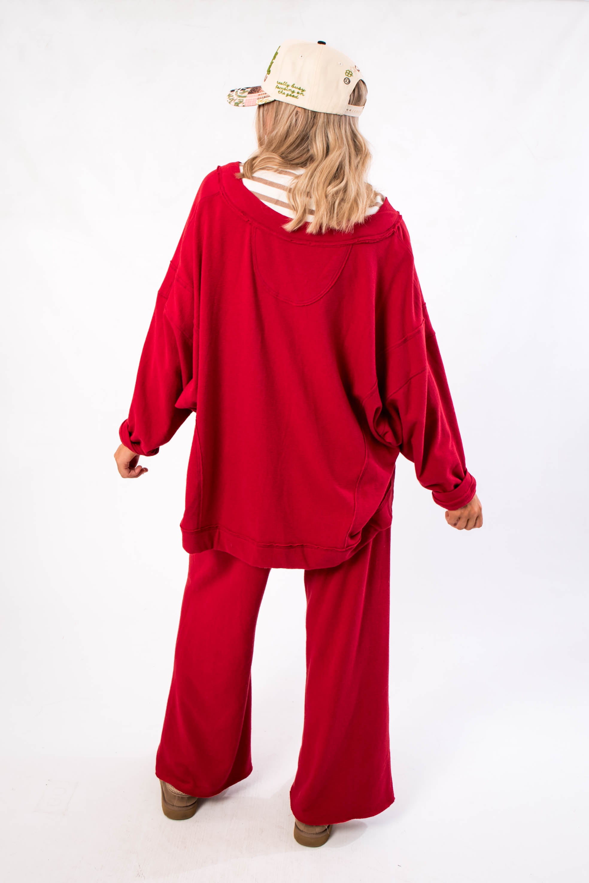 Free People Deep Cherry Staycation Pullover – Back view of oversized cherry red sweatshirt with relaxed hem and soft fabric, perfect for lounging.