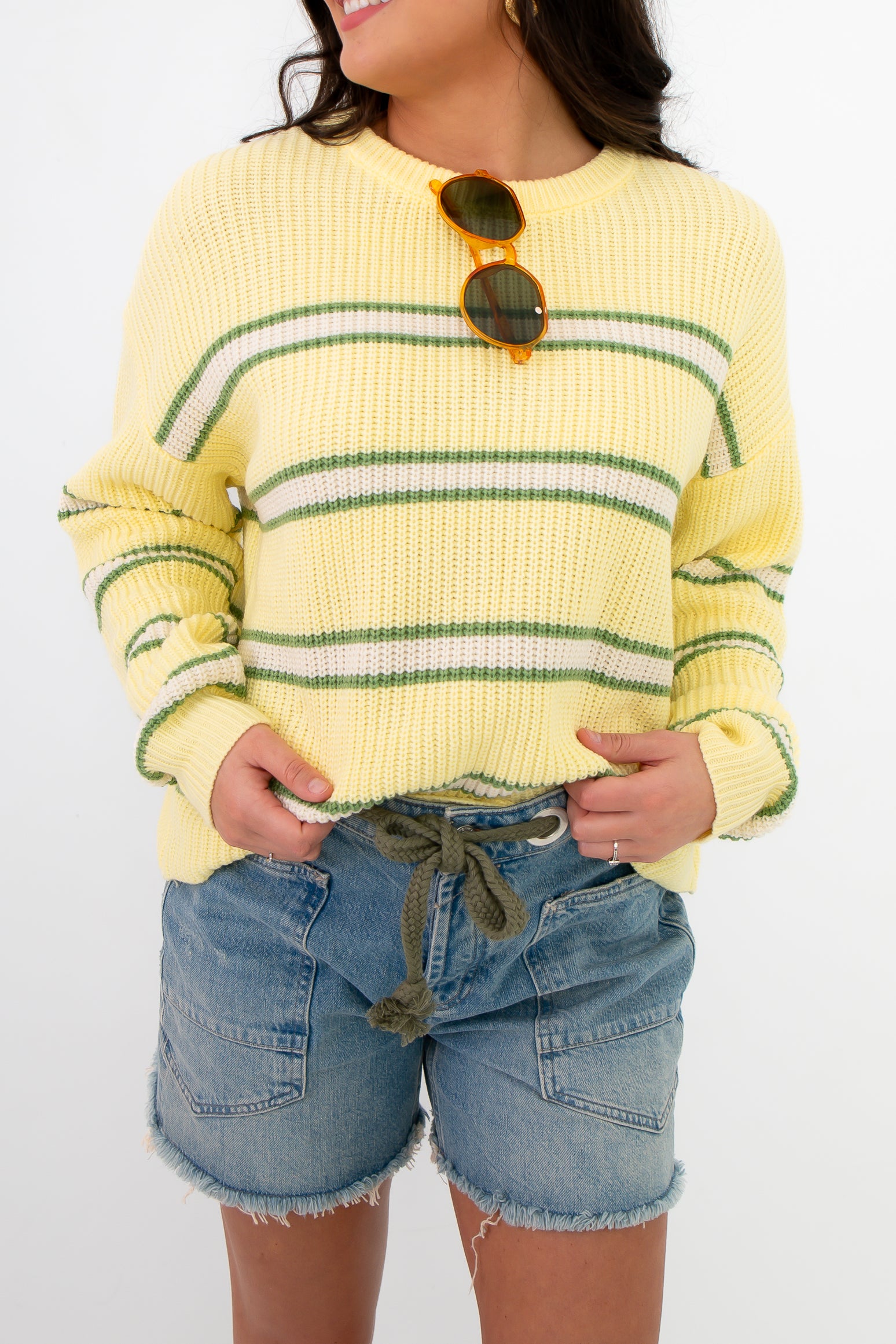 Close-up of Country Club Stripe Knit Sweater featuring soft yellow knit with green stripes and ribbed texture. Ideal for layering in warm weather.