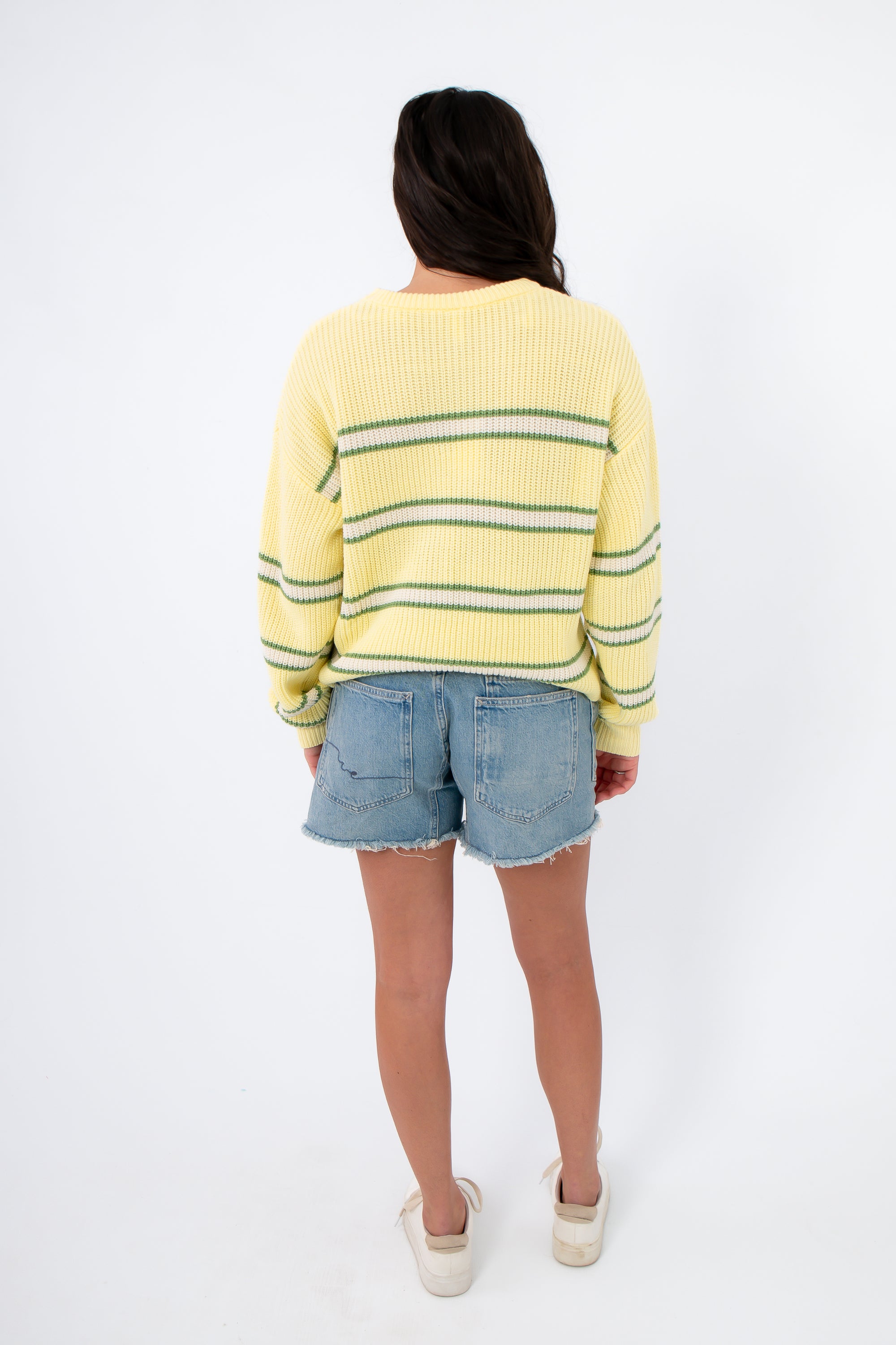 Back view of Country Club Stripe Knit Sweater in yellow with green stripes. Lightweight cotton sweater perfect for layering in transitional seasons.