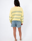 Back view of Country Club Stripe Knit Sweater in yellow with green stripes. Lightweight cotton sweater perfect for layering in transitional seasons.