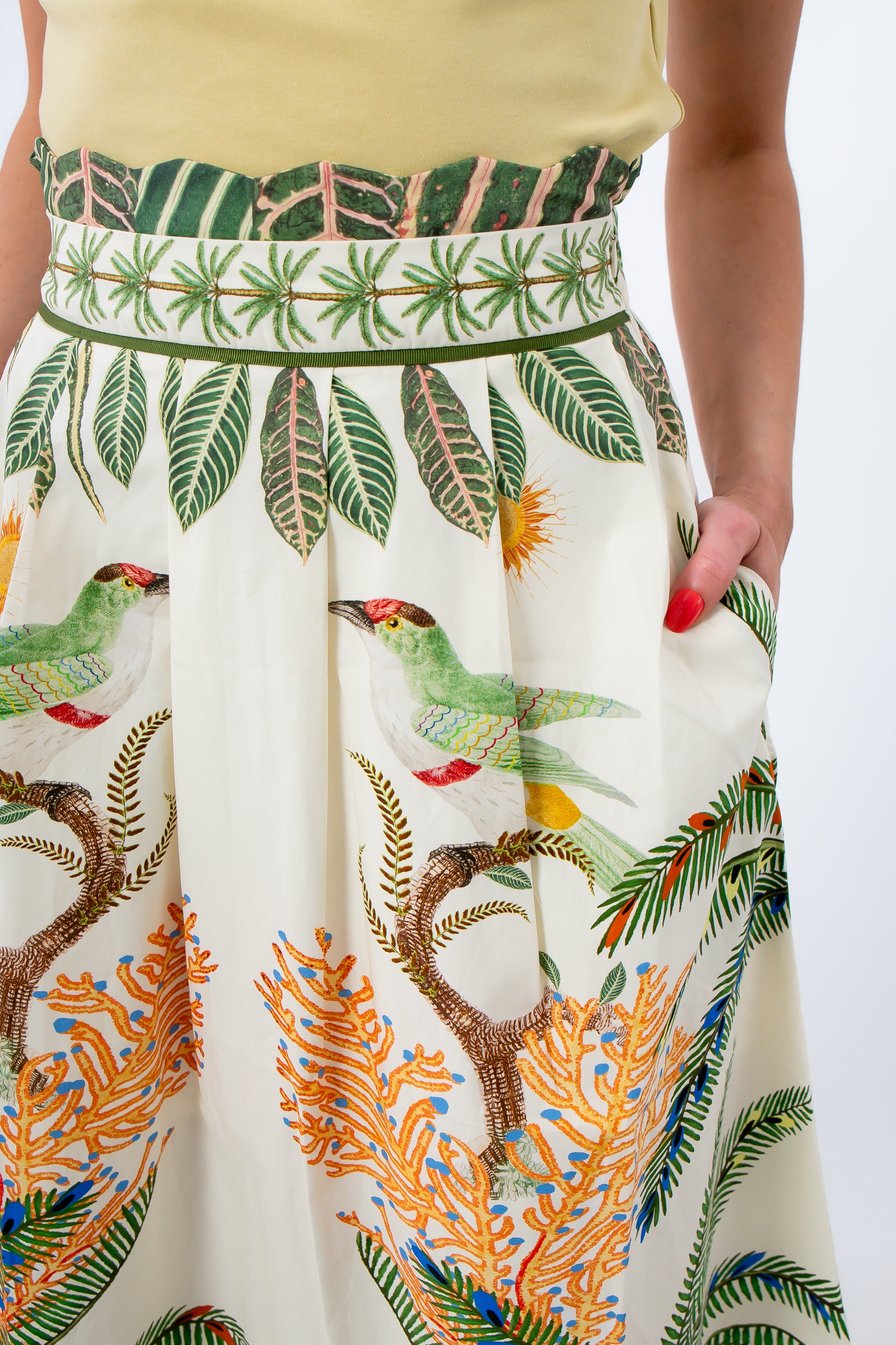 Close-up of tropical print midi skirt with palm trees and bird illustrations, high waist