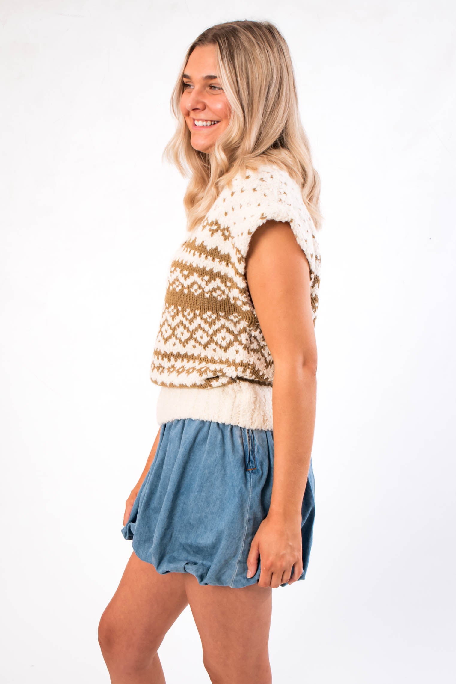 Side profile of Steve Madden Paulie Sweater Vest showing textured knit pattern and cap sleeves, styled for casual women’s outerwear fashion.