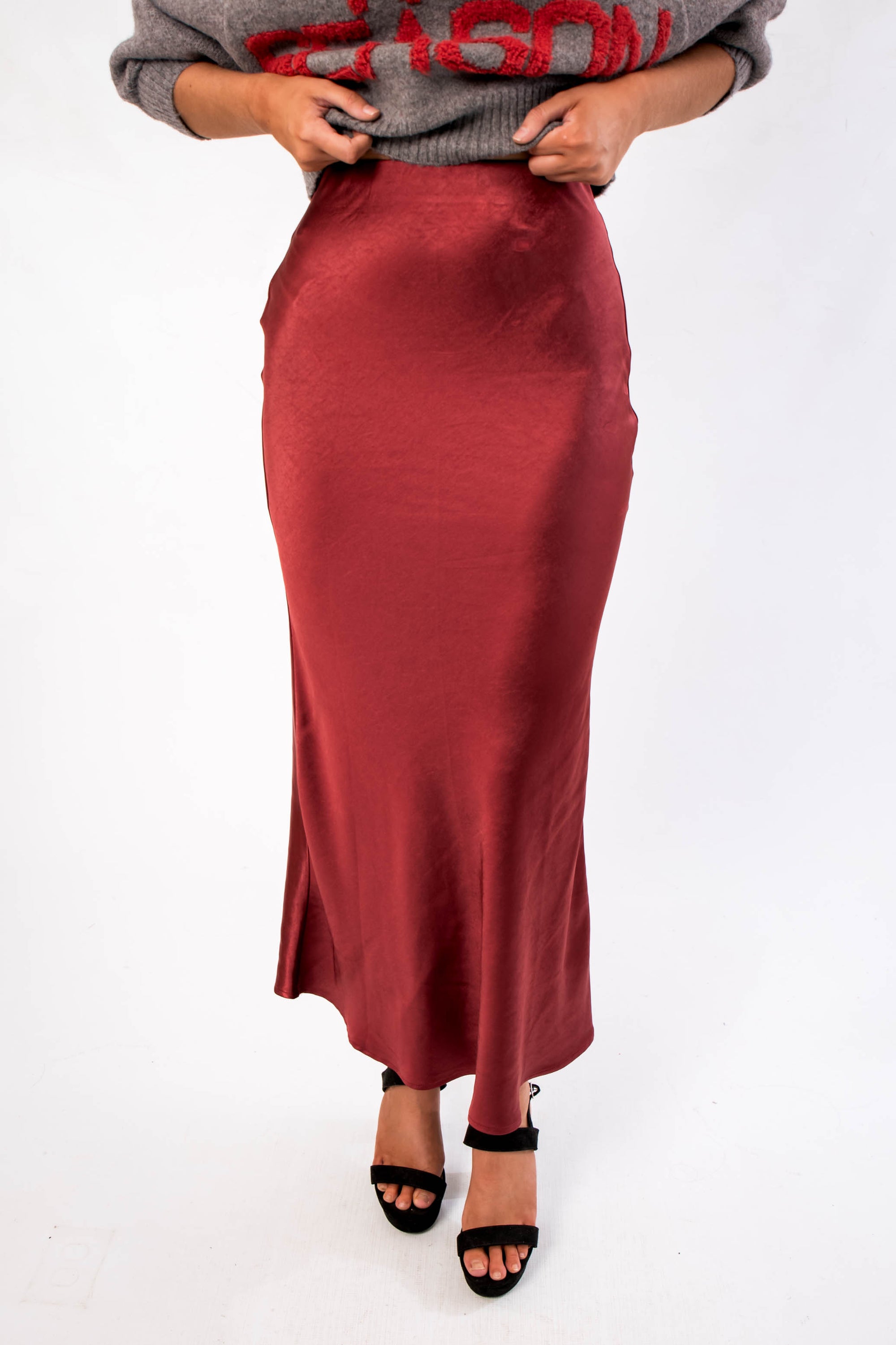 Close-up of the Cabernet Crush Satin Midi Skirt showcasing its smooth satin texture and flattering bias-cut silhouette.