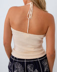 Ecru halter neck knit top with shells for summer vacation