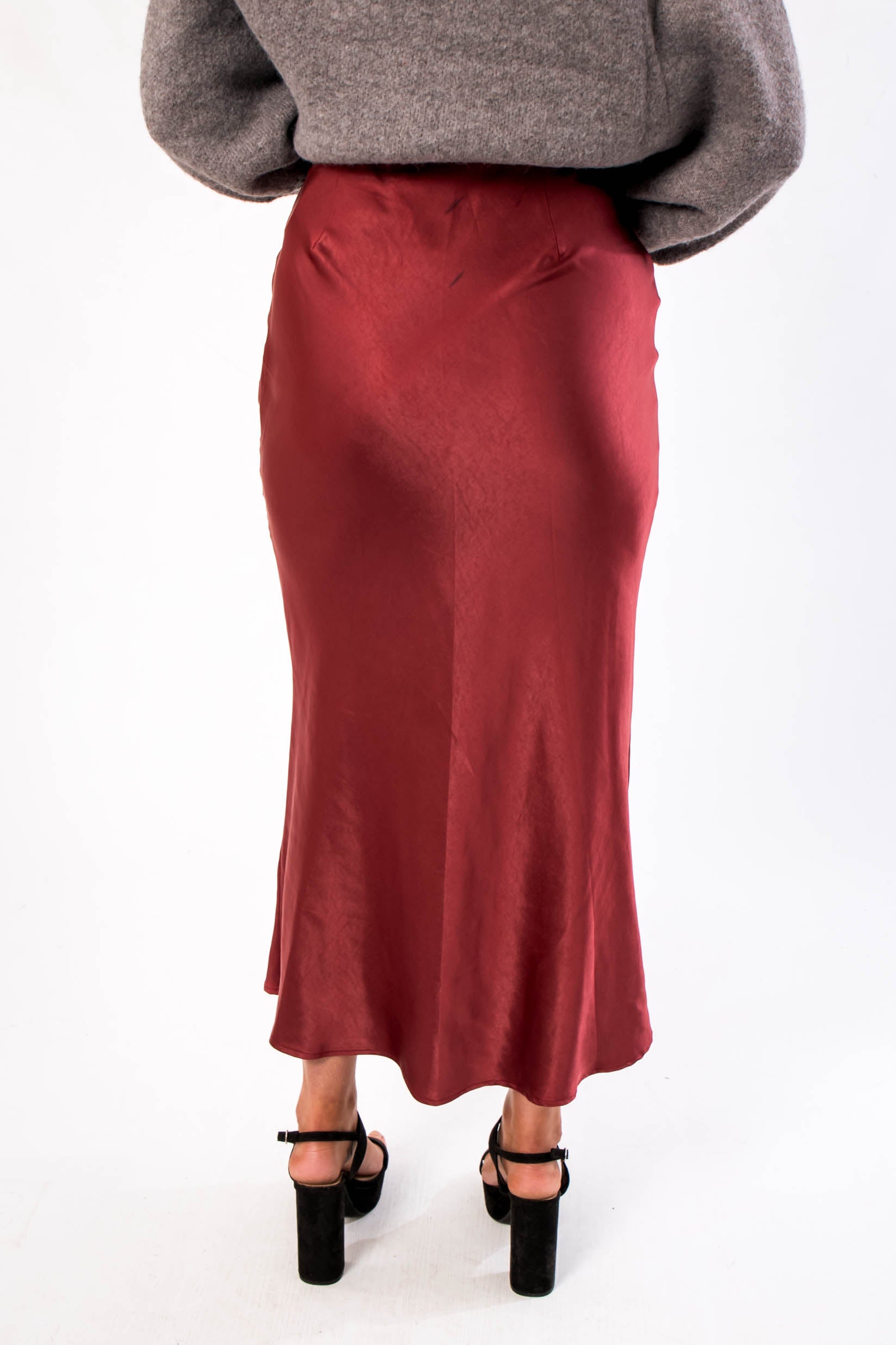Back view of the Cabernet Crush Satin Midi Skirt in wine red, featuring a sleek finish ideal for holiday and party wear.