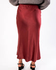 Back view of the Cabernet Crush Satin Midi Skirt in wine red, featuring a sleek finish ideal for holiday and party wear.