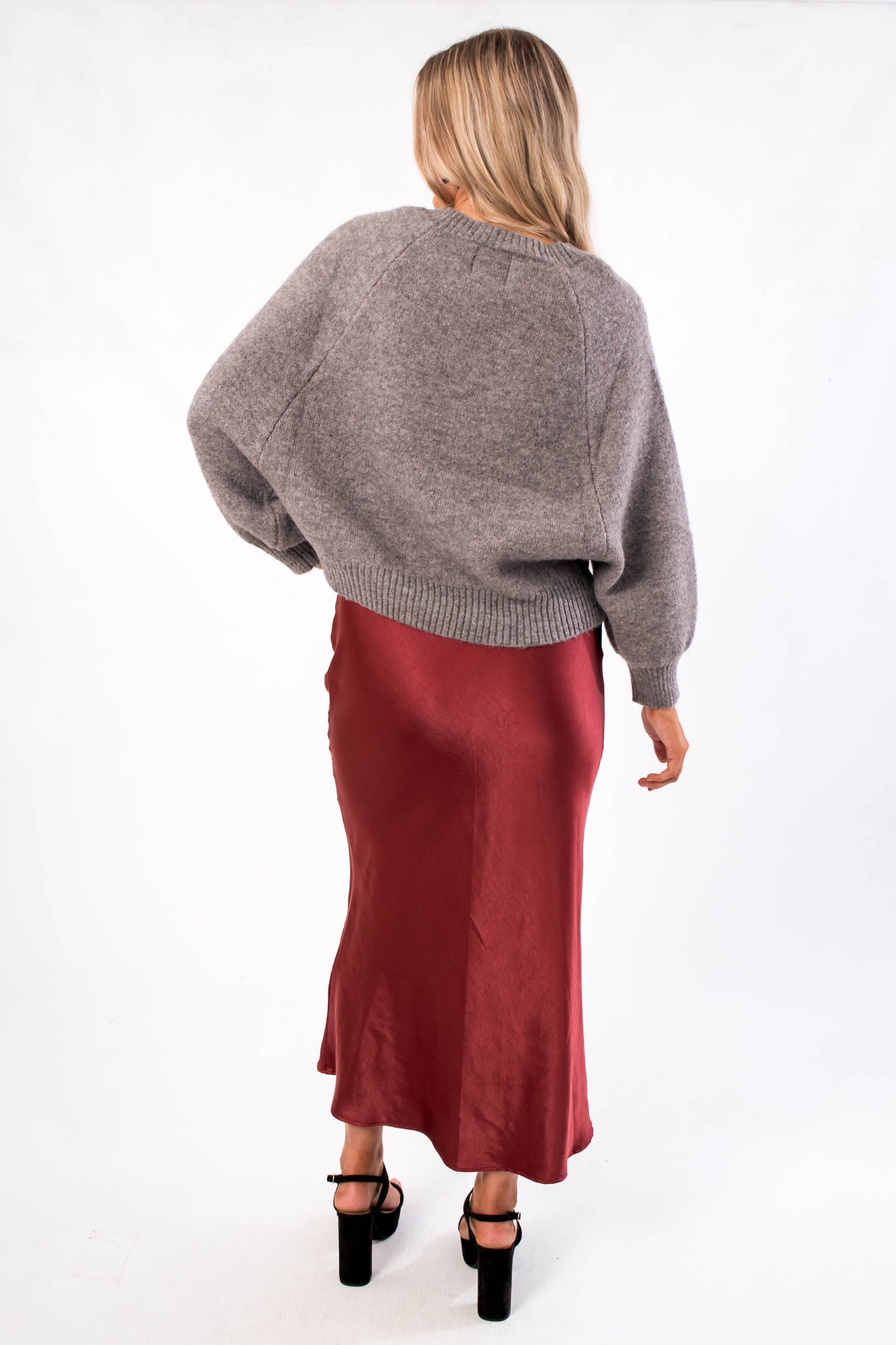 Back view of 'Tis The Season Charcoal Sweater | Cozy Holiday Pullover for Women highlighting ribbed hem and plush knit fabric for winter comfort.