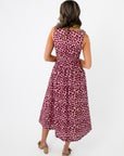 Back view of THML Tini Pink Polka Dot Midi Dress with a cinched waist and flowy midi-length skirt, ideal for stylish summer outings.