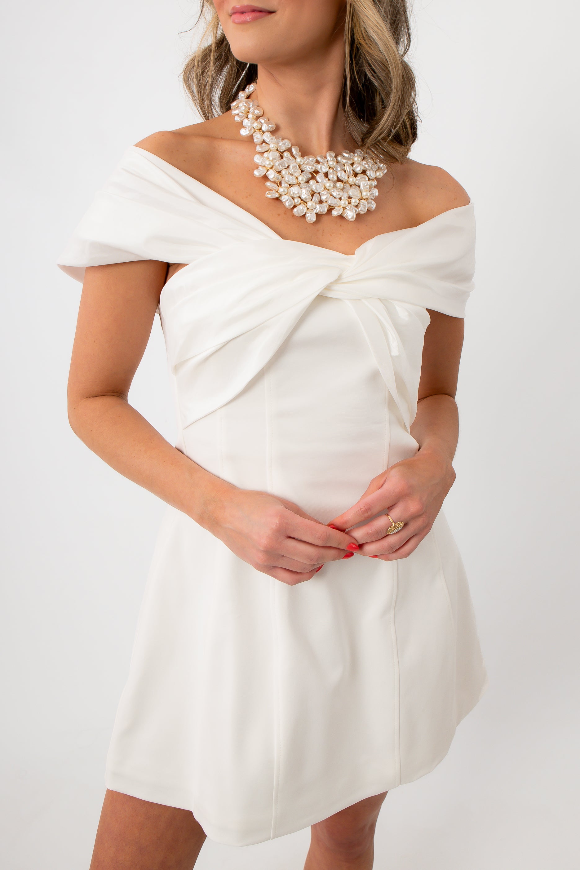 Elegant white mini dress with off-shoulder draped neckline for party wear