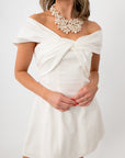 Elegant white mini dress with off-shoulder draped neckline for party wear