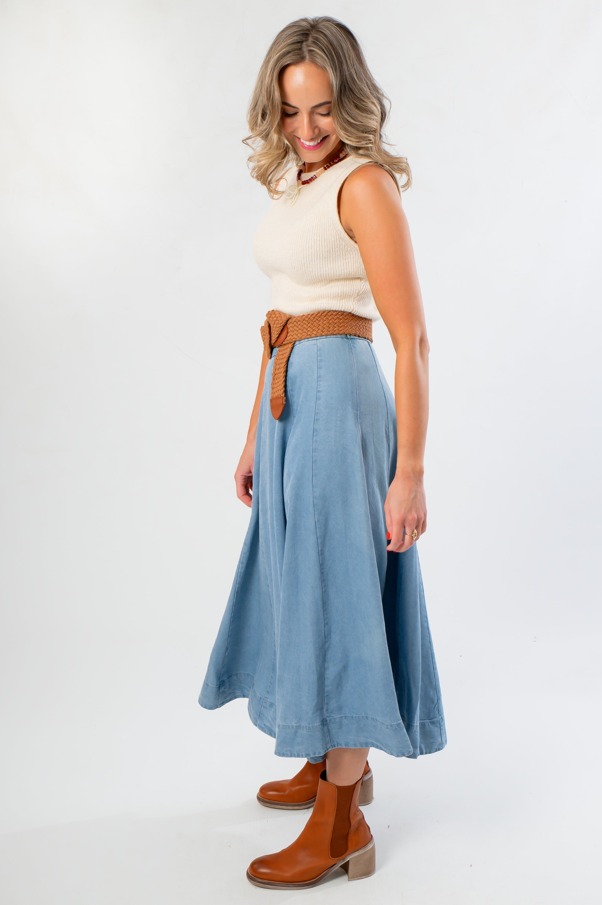 Side view of Washed Denim Paneled Midi Skirt paired with a woven belt and ankle boots, ideal for autumn layering.