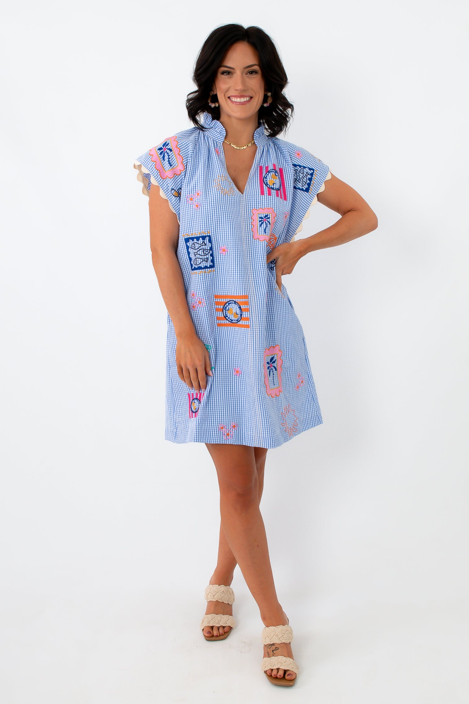 Blue gingham embroidered dress with colorful patchwork details, ruffled sleeves, and lightweight fabric for summer wear