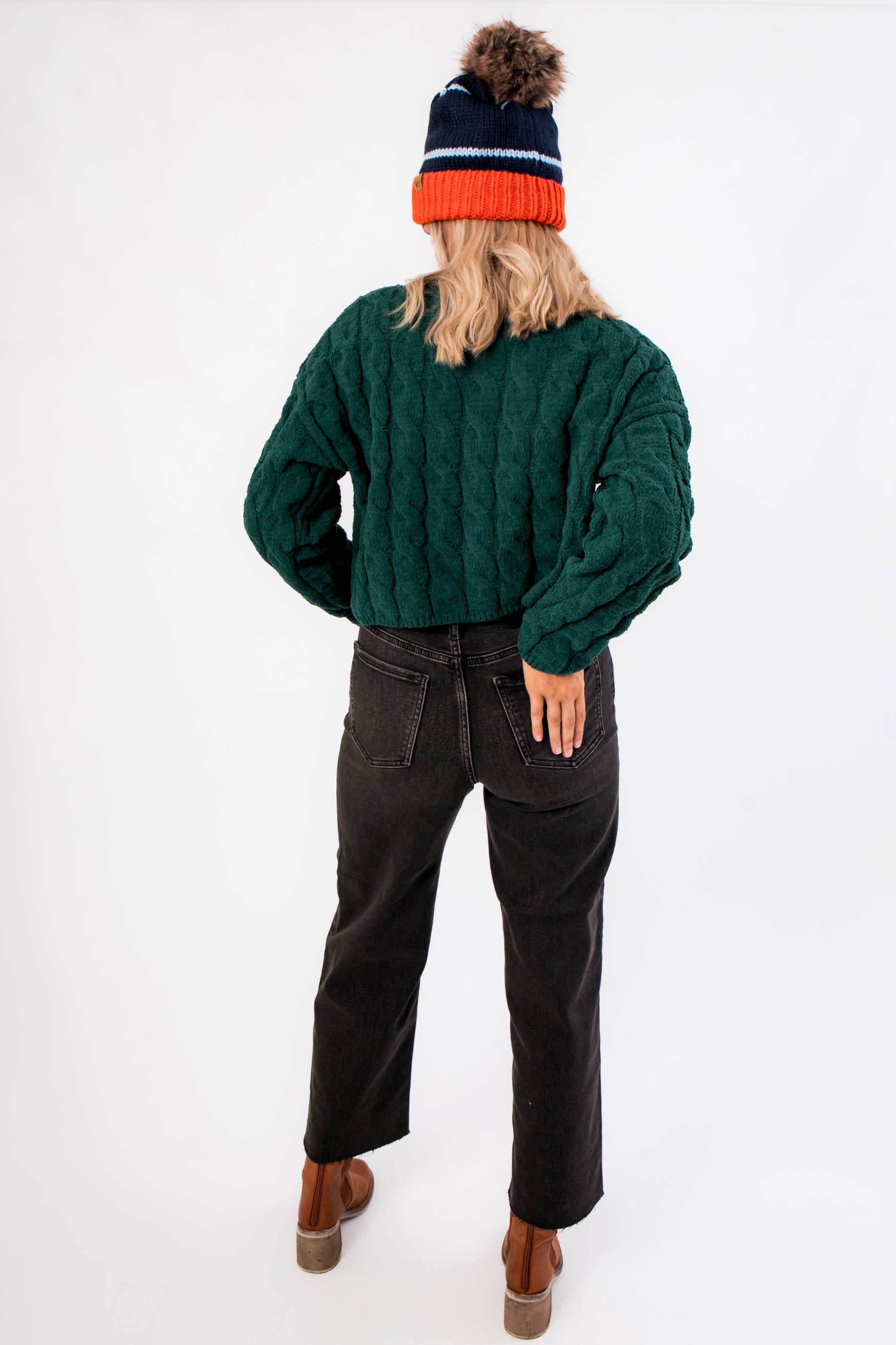 Back view of Tree Farm Stroll Cable-Knit Sweater in rich green, highlighting its relaxed silhouette and textured knit pattern for holiday wear.