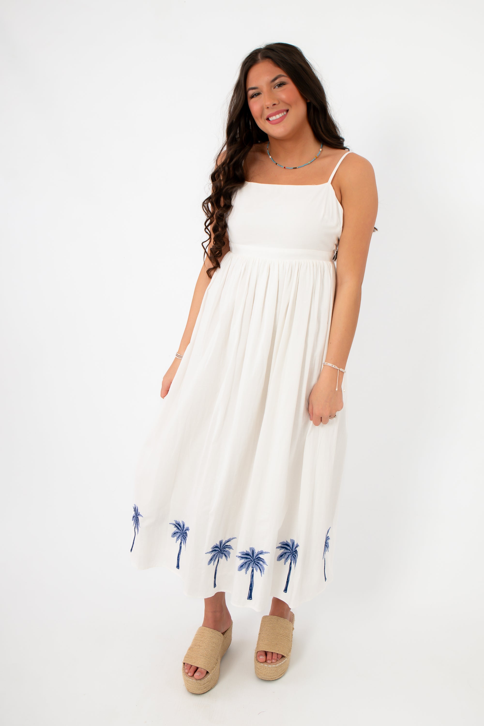 Front view of MINKPINK Isadora Palm Embroidered Midi Dress, a summer palm tree outfit with a relaxed fit and beachy embroidered hem.