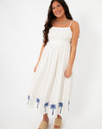 Front view of MINKPINK Isadora Palm Embroidered Midi Dress, a summer palm tree outfit with a relaxed fit and beachy embroidered hem.