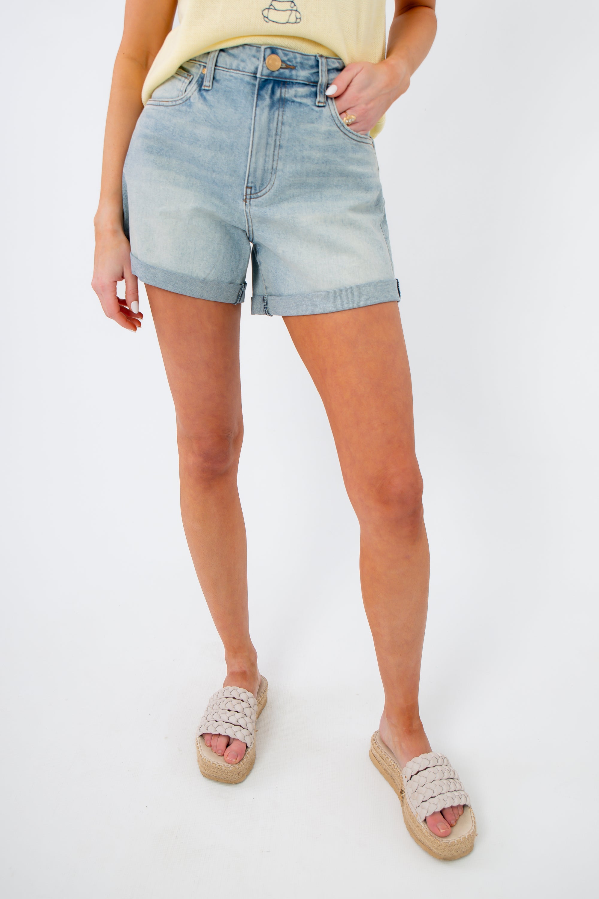 Full front view of Kut from the Kloth Wonder Taylor High Rise Short styled with casual sandals, ideal for warm-weather outfits.