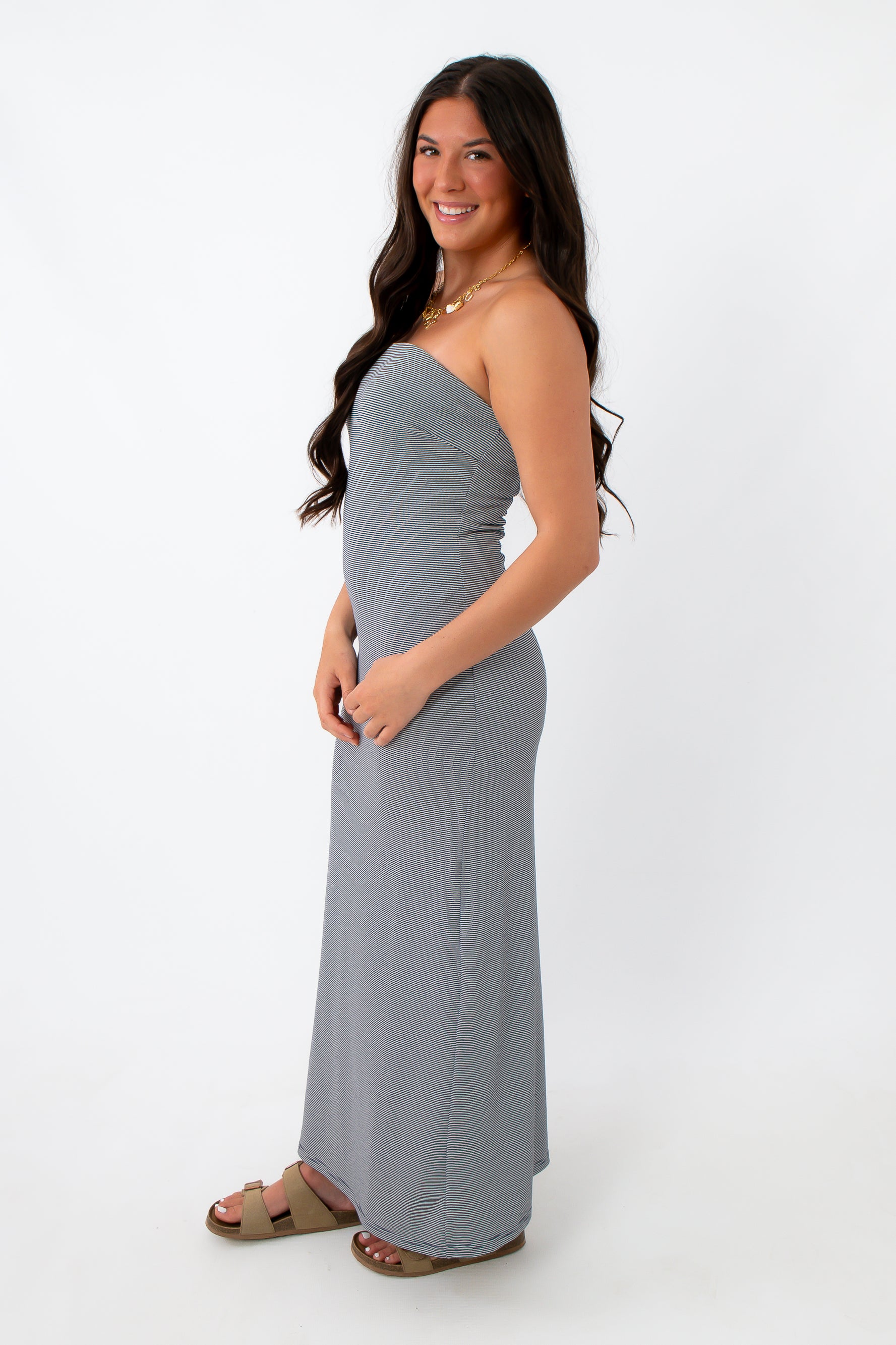 Back view of navy stripe strapless maxi dress on model for summer vacation