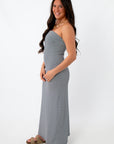 Back view of navy stripe strapless maxi dress on model for summer vacation