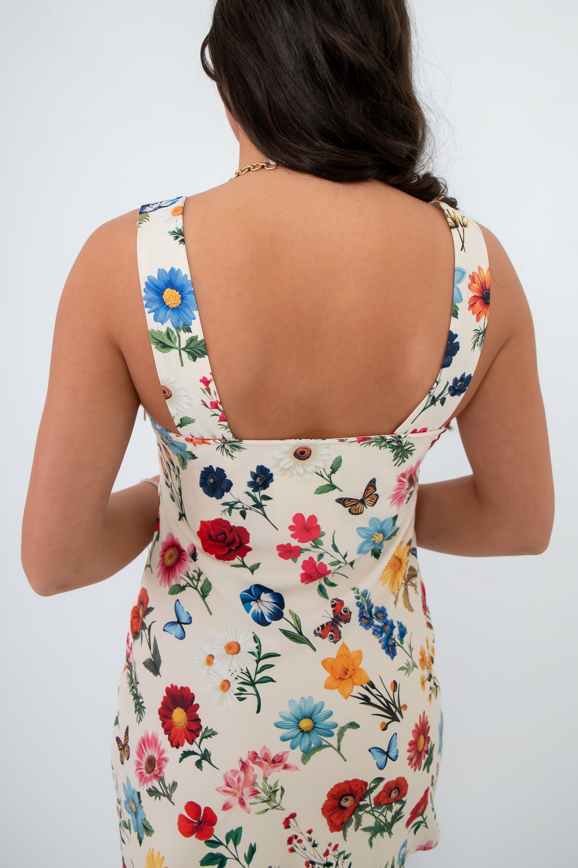 Close-up of the back of the Show Me Your Mumu French Floral Emily Mini Dress highlighting the vivid floral print and square neckline detail.