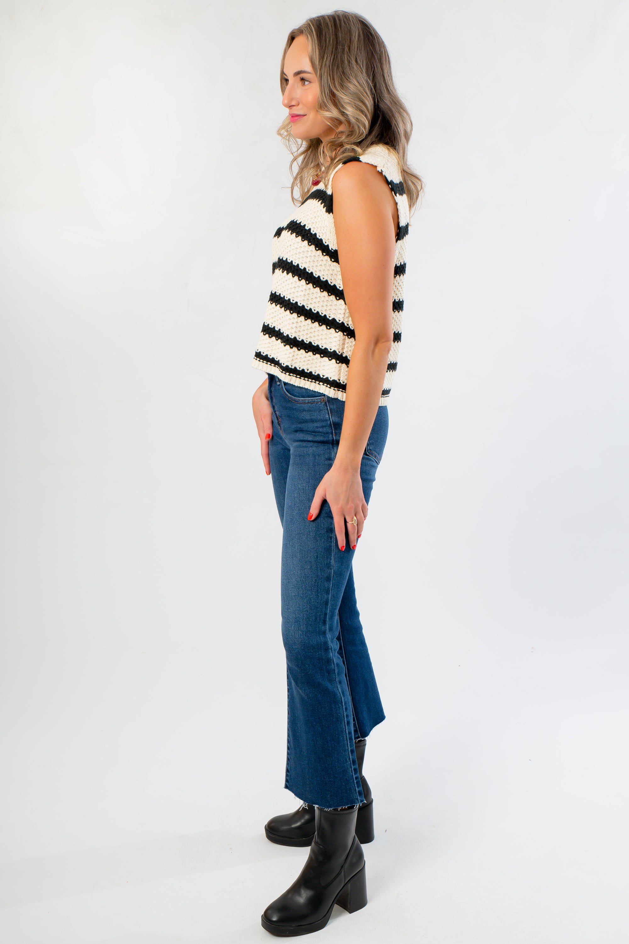 Side view of Oreo Striped Sleeveless Sweater showing chunky knit texture and relaxed fit, perfect for layering in cool weather.