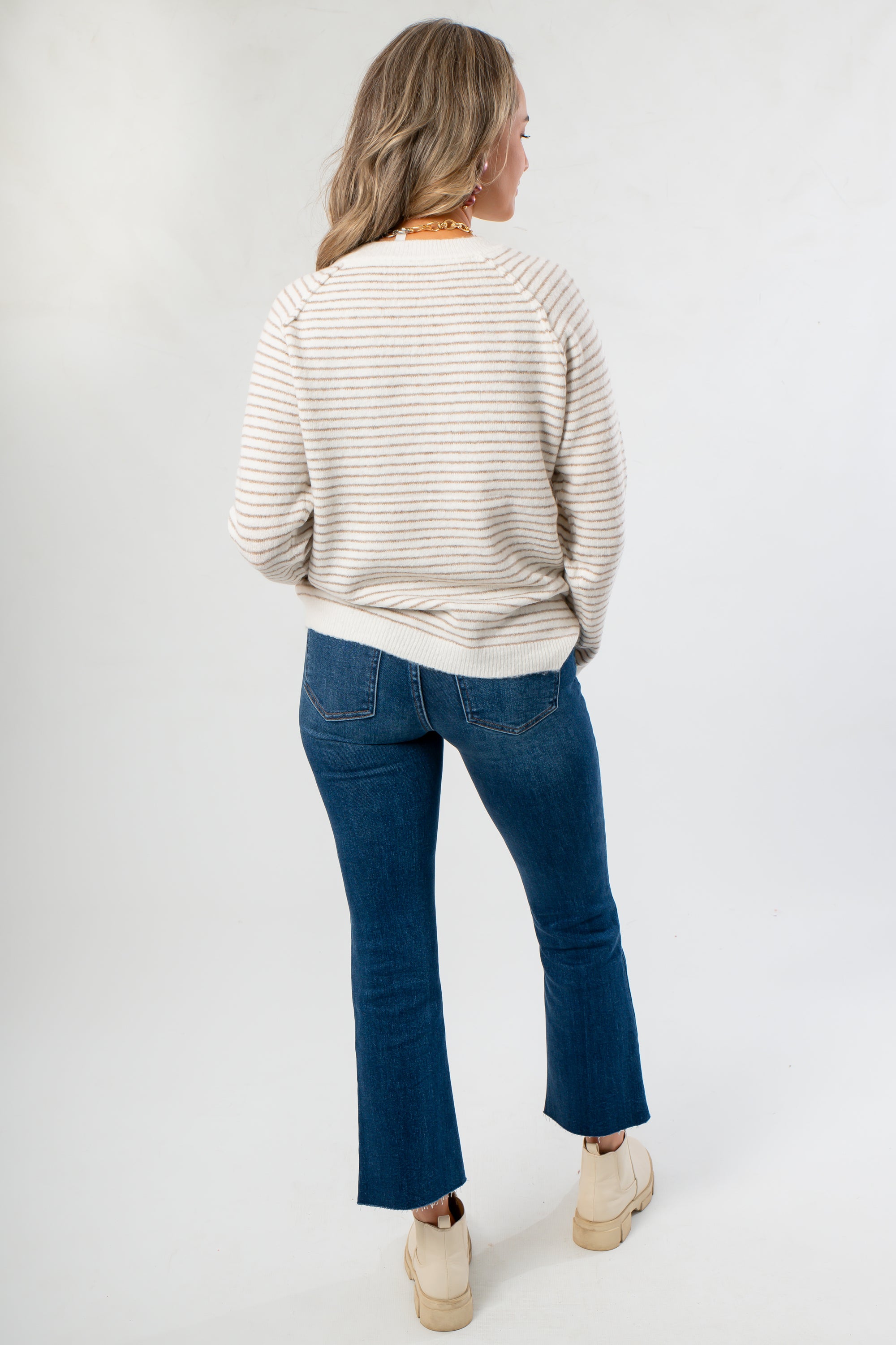 Back view of Cozy Taupe Stripe Long Sleeve Sweater highlighting its relaxed silhouette and neutral stripe pattern for versatile styling.