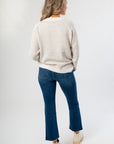 Back view of Cozy Taupe Stripe Long Sleeve Sweater highlighting its relaxed silhouette and neutral stripe pattern for versatile styling.
