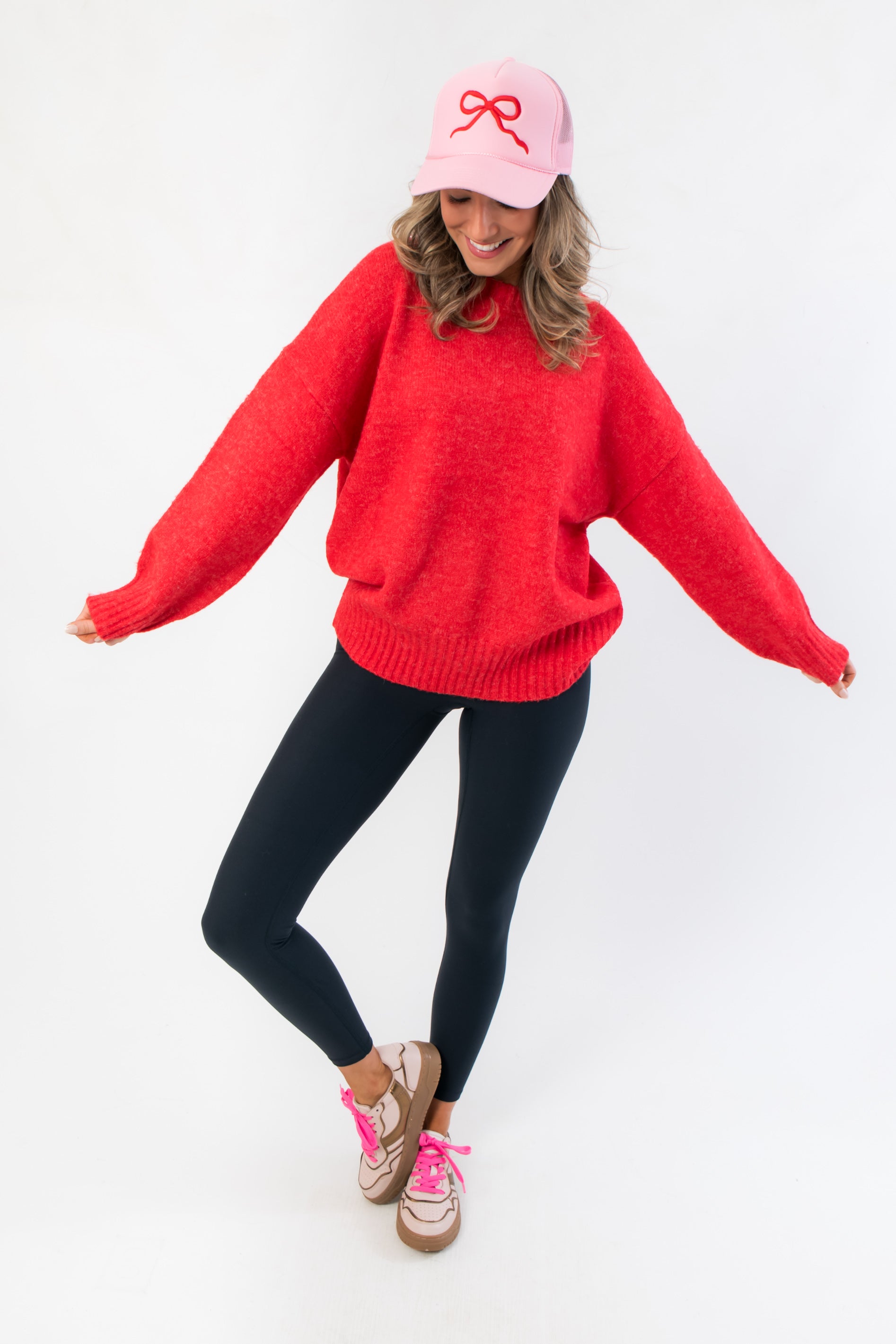 Festive Candied Cherry Red Knit Sweater paired with casual leggings and sneakers, perfect for holiday parties or cozy seasonal wear.