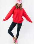 Festive Candied Cherry Red Knit Sweater paired with casual leggings and sneakers, perfect for holiday parties or cozy seasonal wear.