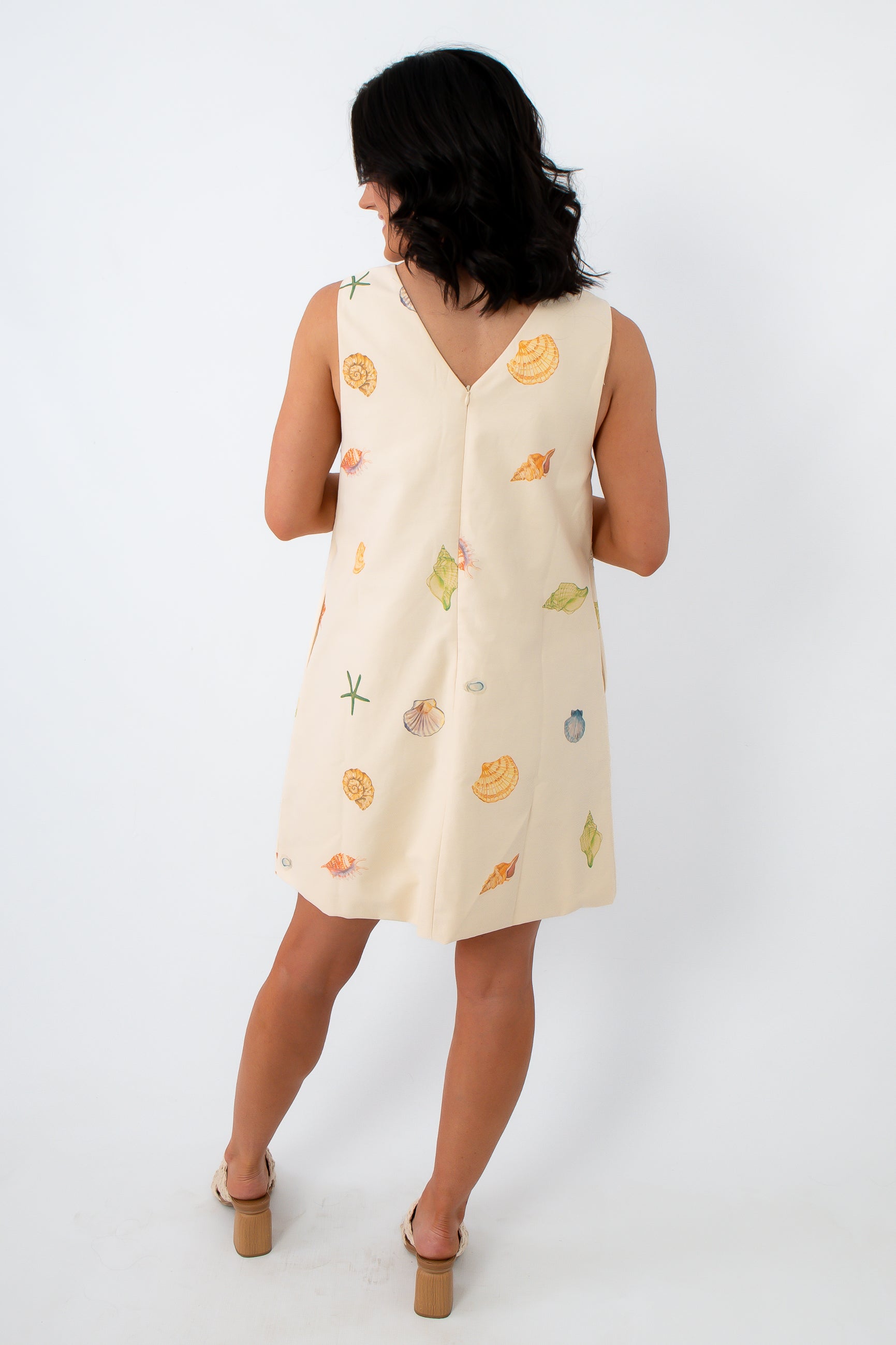 Cream shell print beach dress with eyelet details and pockets for summer vacations