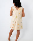Cream shell print beach dress with eyelet details and pockets for summer vacations