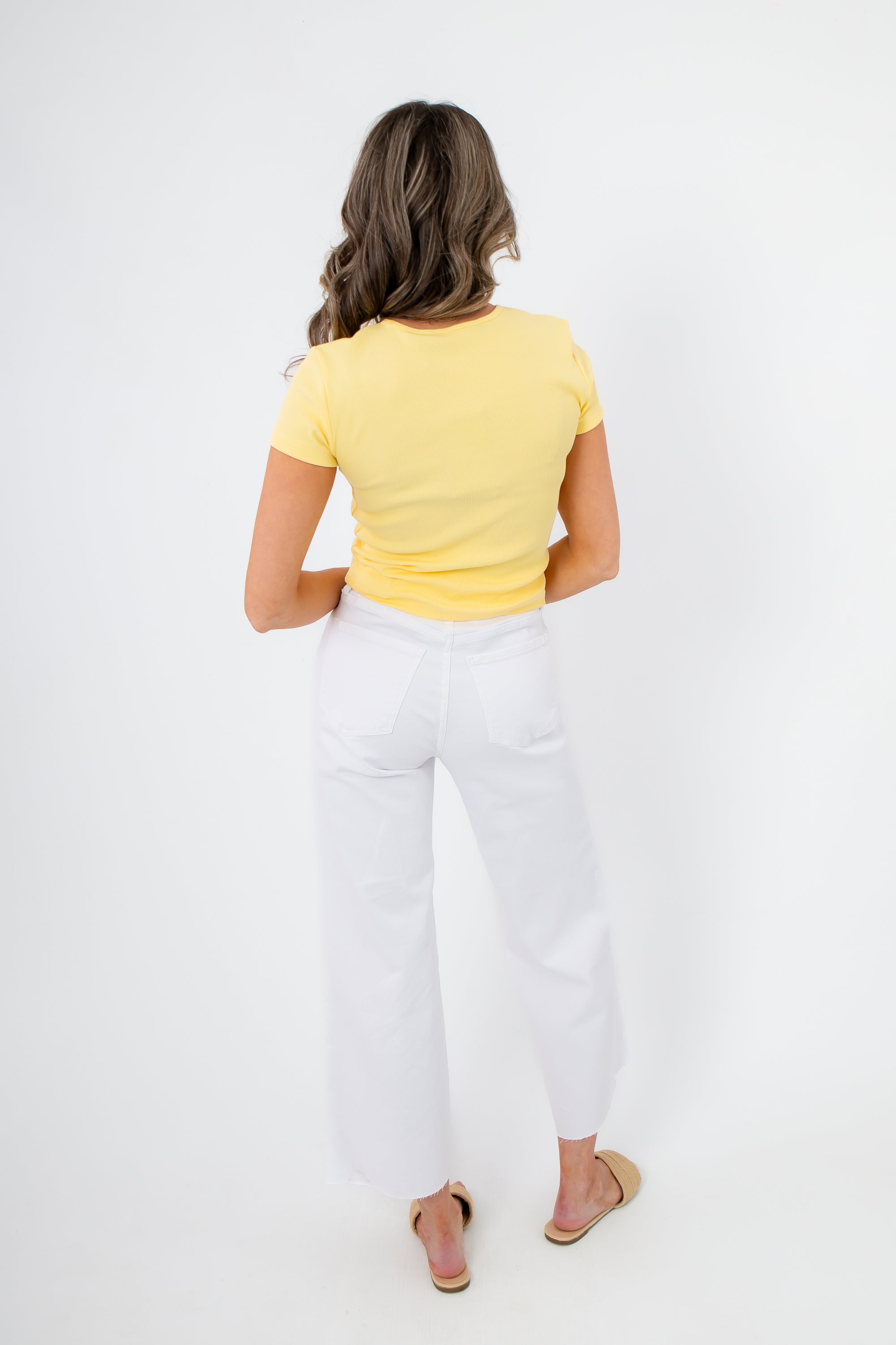 Back view of Lemon Drop Essential Short Sleeve Tee showing its snug fit and stretch fabric, ideal for everyday summer comfort and style.