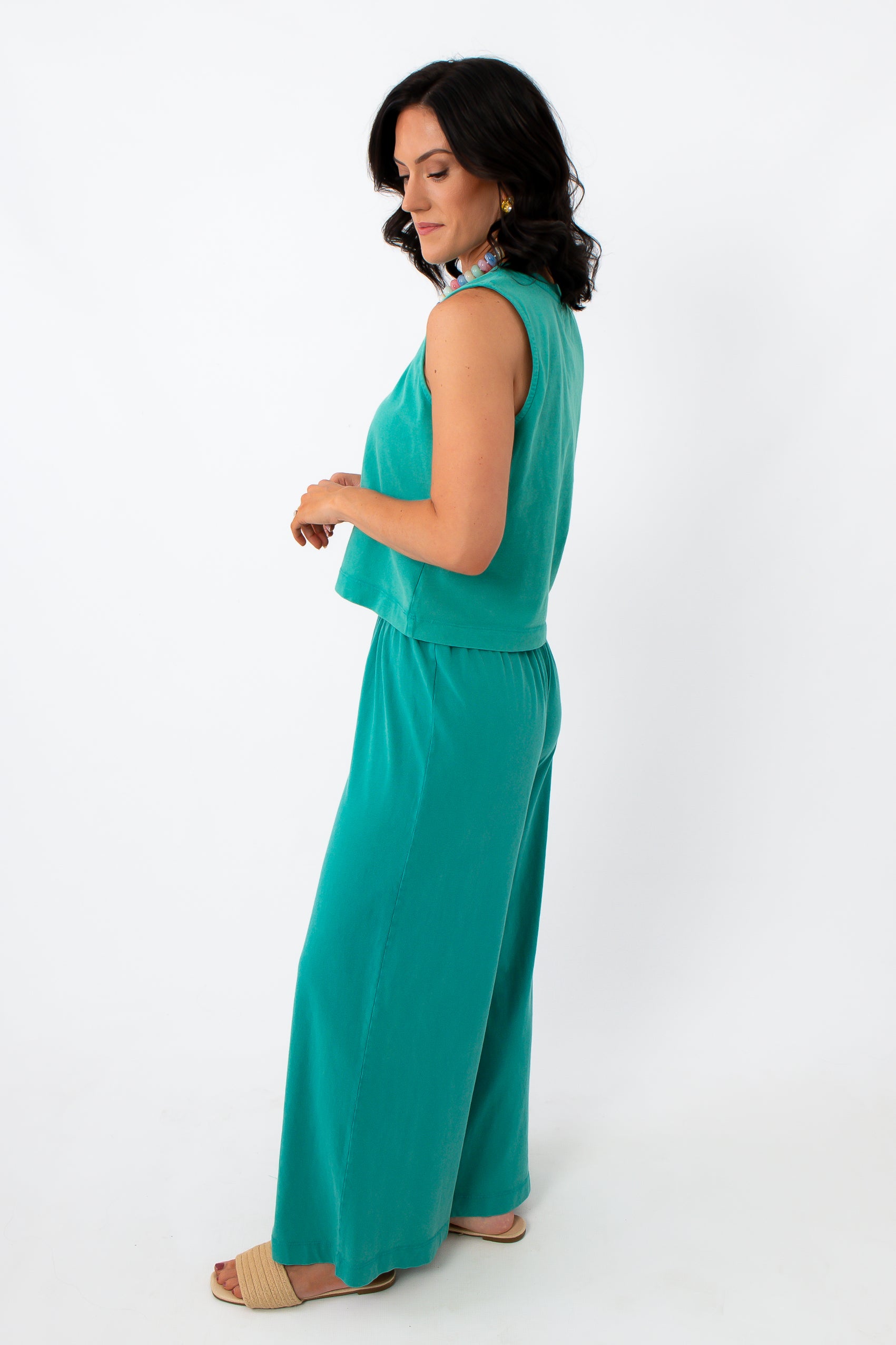 Back view of women in teal sleeveless lounge top and wide-leg pants