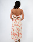 Shelby Red Seashell Printed Strapless Dress with coastal shell motifs in red on cream fabric, featuring a back-tie bow and flowy midi length.