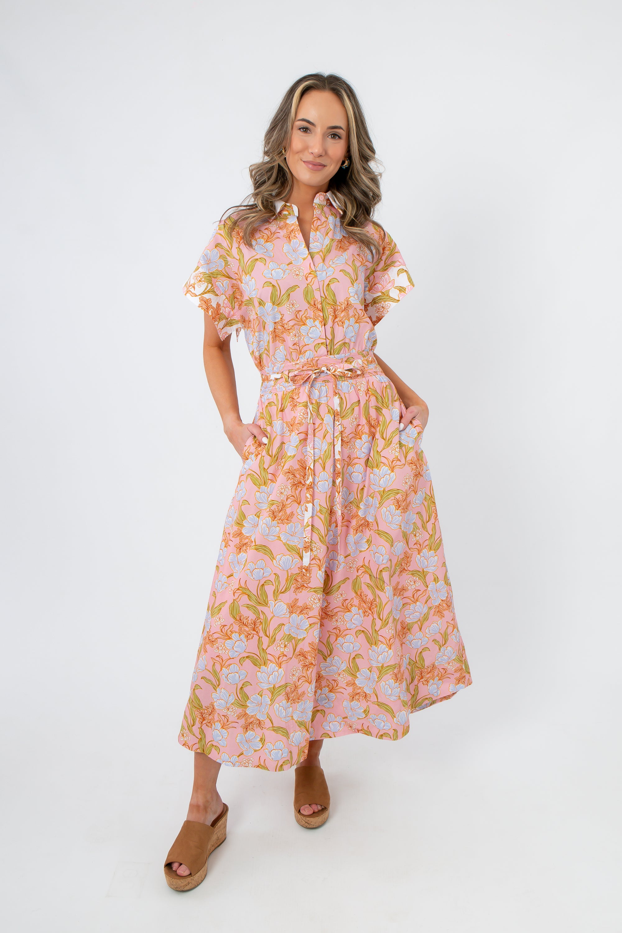 Model wearing Coral Gables Floral Midi Shirt Dress with short sleeves, belted waist, and floral print, styled for spring or summer outings.