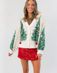 Cozy & Chic Christmas Tree Plush Cardigan with festive green tree design, worn with red sequin skirt for a cute holiday outfit.
