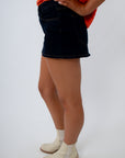 Neutral game day outfit, dark denim skort, black denim mini skort
