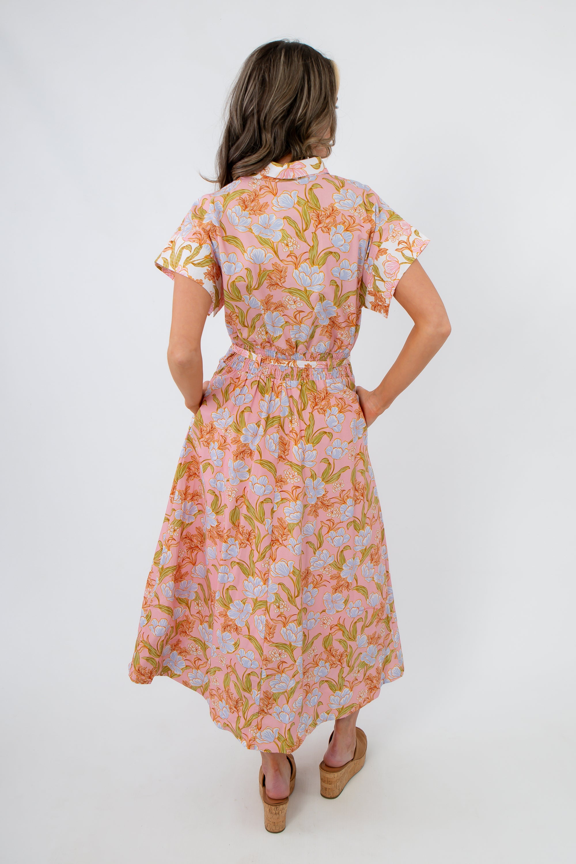 Back view of Coral Gables Floral Midi Shirt Dress showing elastic waist and soft pleats, ideal for casual or resort wear.