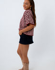 Burgundy Checkered Short Sleeve Sweater paired with black denim mini skort for USC game day outfit