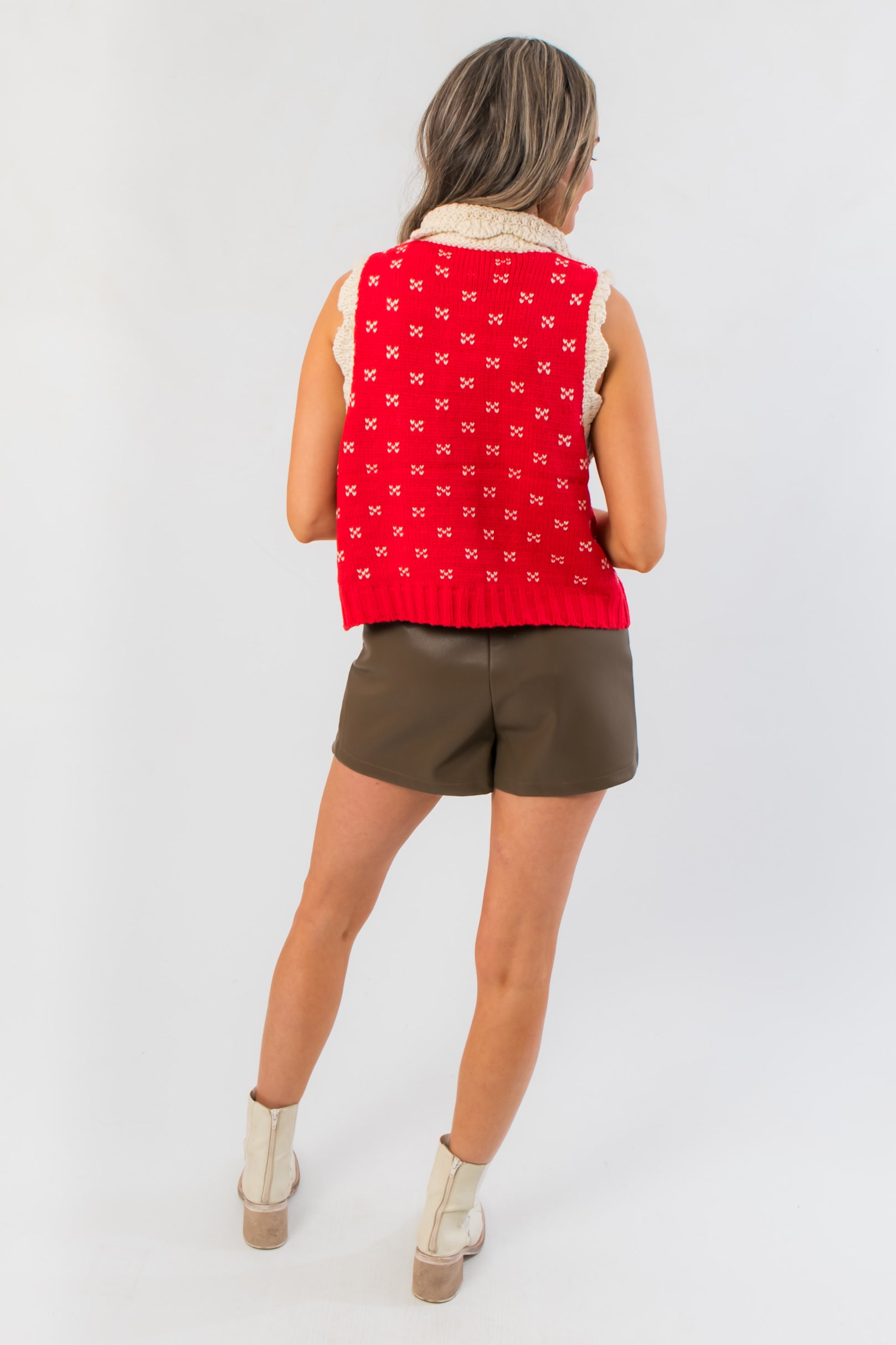 Back view of Clara Collared Knit Sweater Vest highlighting red knit pattern with cream accents, perfect for stylish seasonal outerwear looks.