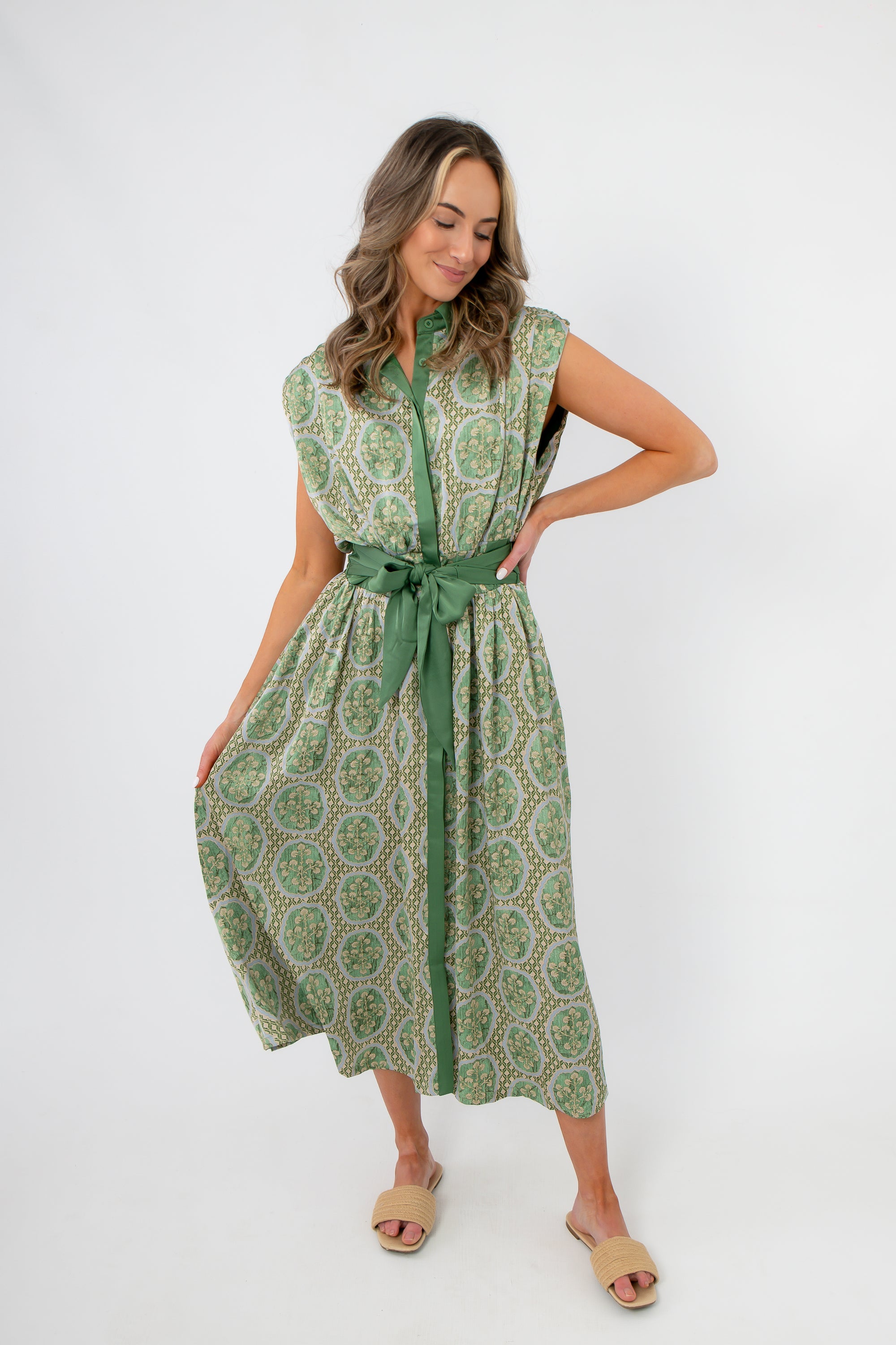 Emerald Deco Printed Satin Midi Dress featuring a sleeveless cut, green belt, and elegant Art Deco print for stylish occasions.