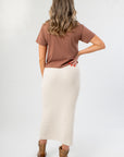 Back view of It's Gameday Camo Crop Graphic Tee – Stylish Neutral Crop Top showing solid brown fabric and relaxed fit, styled with a ribbed midi skirt.