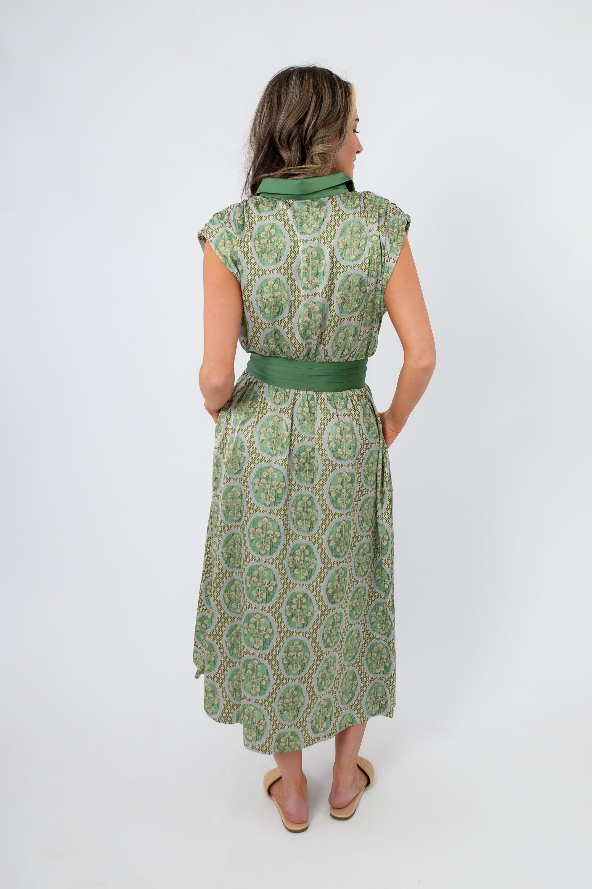 Back view of Emerald Deco Printed Satin Midi Dress featuring green Art Deco pattern and wide satin waistband. Ideal for weddings and summer parties.
