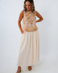 Cream and orange shell print top paired with cream maxi skirt for a classic summer look
